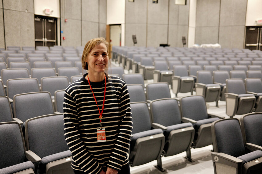 Dorene Phillips, a music teacher at Portsmouth High School, stands inside the newly refurbished Little Theater. Phillips spearheaded efforts to acquire new seating, sound, lighting, curtains, carpeting and a paint job for the 53-year-old auditorium.