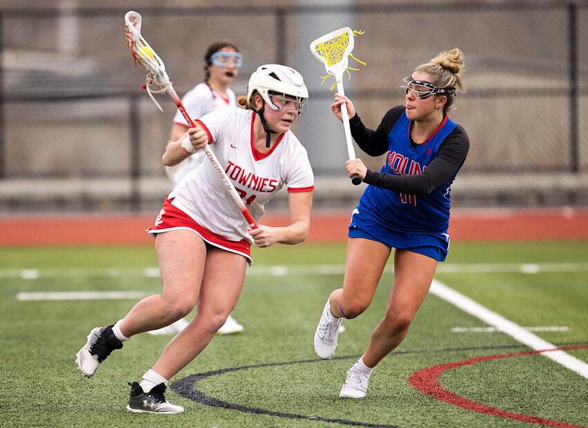 Kenna Wigginton (left) drives towards goal during the EPHS girls' lacrosse game against Mount St. Charles. The senior scored her 100th career goal for the  in the Townies' 15-5 win over neighbor PCD last week.