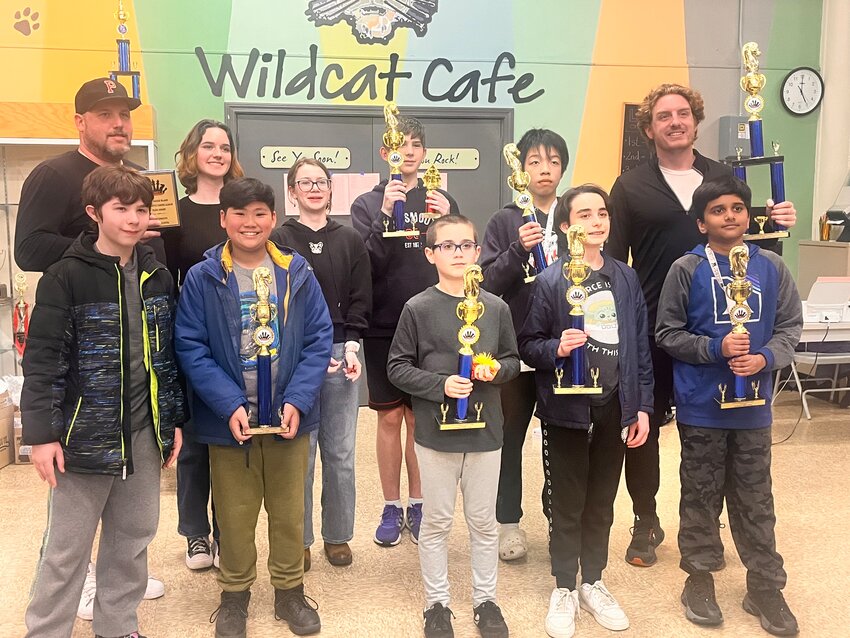 Members of the Portsmouth Middle School chess team pose with their trophies after winning the Southeast New England Chess Association Chess league.&nbsp;They are (back row, from left) Coach Gregg Purdy, Olivia Purdy, Amelia Davis, Patrick Schlesinger, Dan Lu, Coach John DiGangi; and (front row, from left) Chace Bolduc, Dominic Bolos, Charlie Billings, Caleb Thibeault, and Gagan Deep Palya Maruthi.