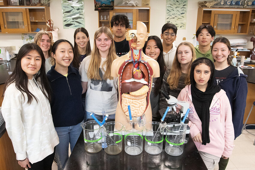 A group of Barrington High School students whose projects scored well at the recent State Science Fair, pose for a photo inside one of the classrooms at the school. BHS junior Estelle Chen and her project earned an invitation to attend the premier science fair in the world, the International Science and Engineering Fair.