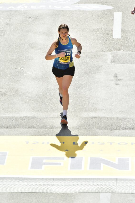 Laura Bell crosses the finish line at The Boston Marathon on Monday.