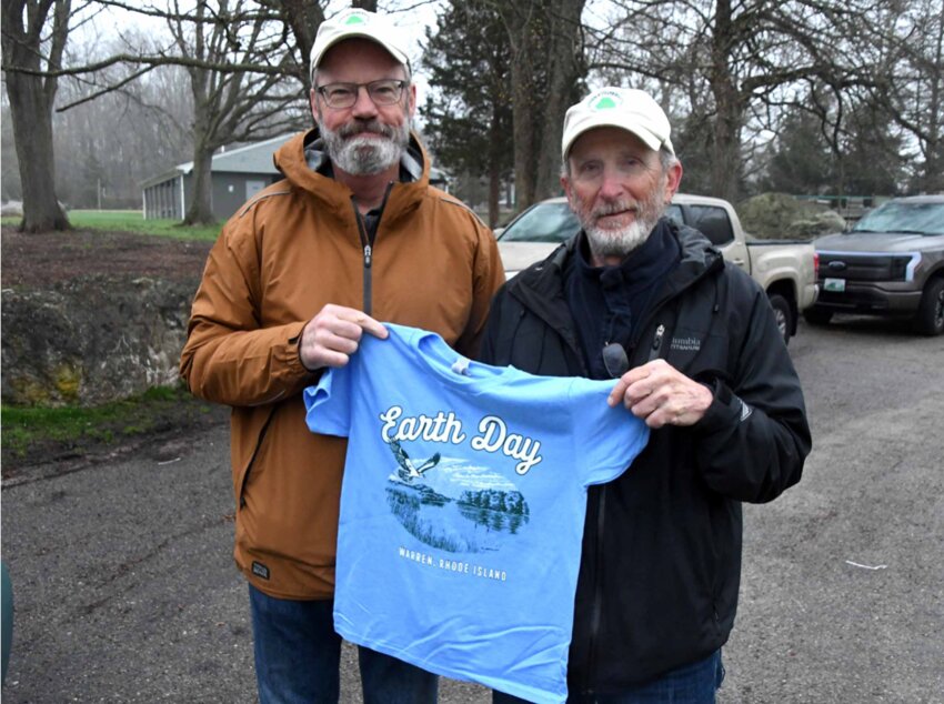 Warren Conservation Commission members Keith Morton and Butch Lombardi hold one of the tee shirts, courtesy of Cliff Prazeres at Dunkin on Metacom, that will be given to anyone who participates in the Earth Day Clean Up on Saturday morning, April 27.