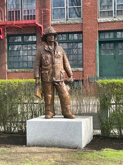 The Firefighter, watching over the Firemen&rsquo;s Memorial Park at Thames and Church streets.