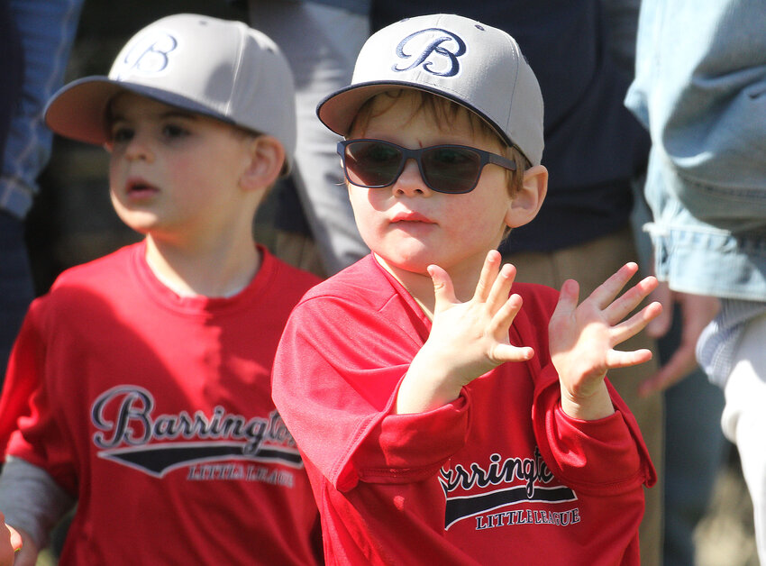 Danny Martens applauds after the National Anthem at Barrington Little League Opening Day on Saturday.