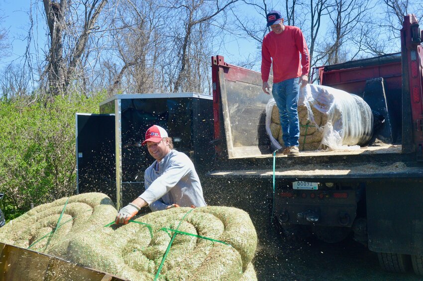Sonny (left) and Cameron Beausoleil of Beausoleil Bros. unload watt spools of straw wattle &mdash;&nbsp;used for erosion control, stabilizing slopes, or filtering stormwater runoff &mdash;&nbsp;off a truck last Friday just outside the dog park. The company is clearing the north and west sides of the Portsmouth Dog Park for a series of fenced-in trails.
