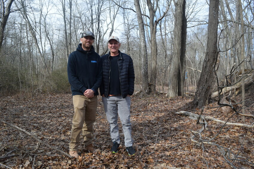 Mike D&rsquo;Ambra (left) and his father, Gary, stand in a section of woods that the D&rsquo;Ambra family recently donated to the Barrington Land Conservation Trust.