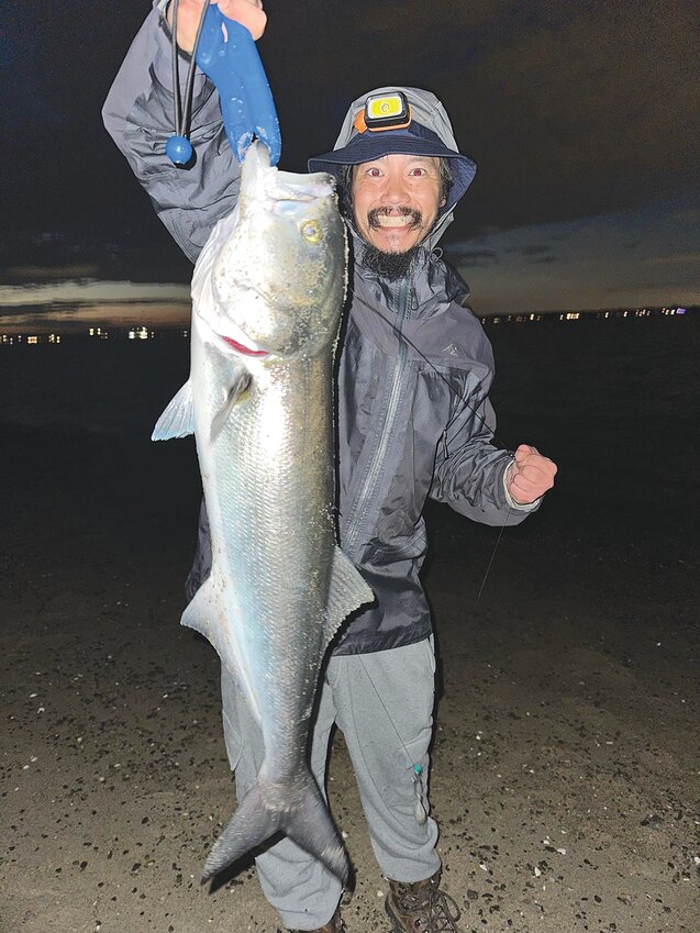 Adam Tam of Worcester with a monster bluefish he caught in Greenwich Bay this week.