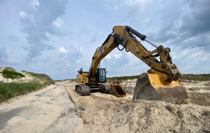 A bulldozer sits idle last month along a widened access path at the Horseneck Beach Reservation.