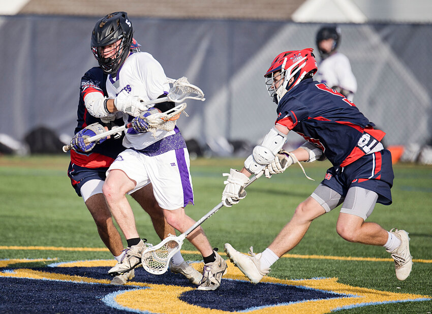 James Thibaudeau splits a pair of Toll Gate defenders to advance the ball toward the goal.