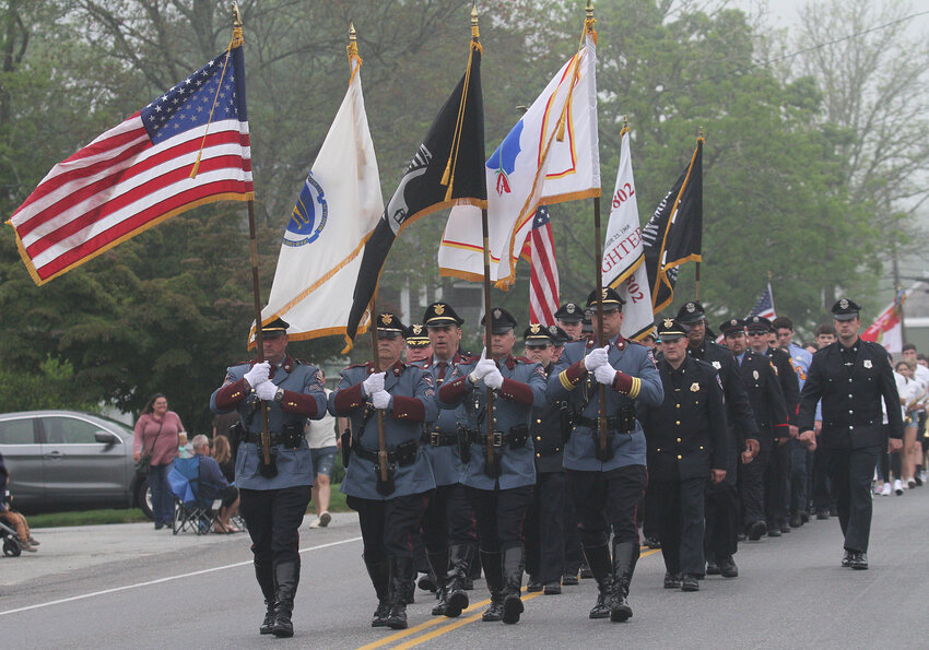The Westport Police color guard lead the police in marching in the parade.