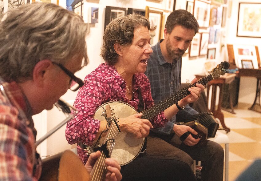 The musicians in the &ldquo;Tunes-day&rdquo; jam in Warren change instruments frequently. Here, Elwood Donnelly (left) plays guitar, Aubrey Atwater plays banjo and Ben Gagliardi plays an English accordion.