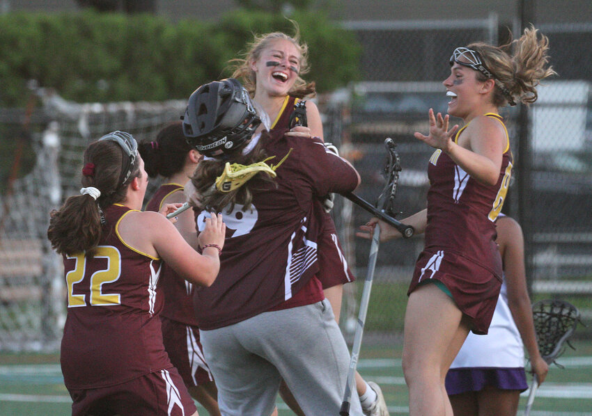 Goaltender Elyse Meyers hoists teammate Zoe Peckham into the air after she scored the game winning goal in overtime as Tiverton beat Classical 15-14 in the Division 4 semifinals on Wednesday.