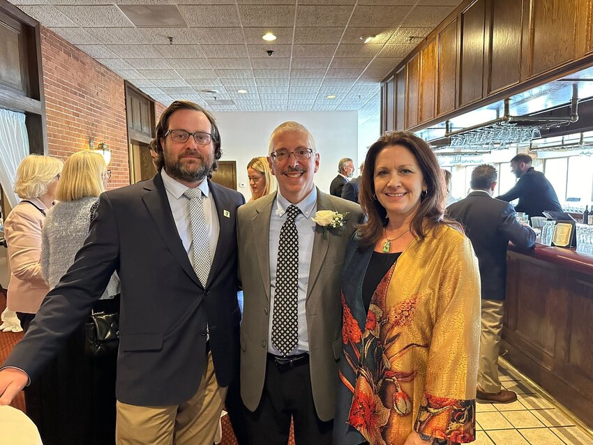 Longtime Bayside Family YMCA Cycle Instructor and Aquatics Coach Bob Hassan (middle) stands with Greater Providence YMCA CEO Karen Santilli (right) and Bayside Y Executive Director Ryan Queenan (left).