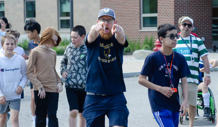 Barrington Middle School teacher Stuart Moran points to the camera while participating in last week's Unity Walk.