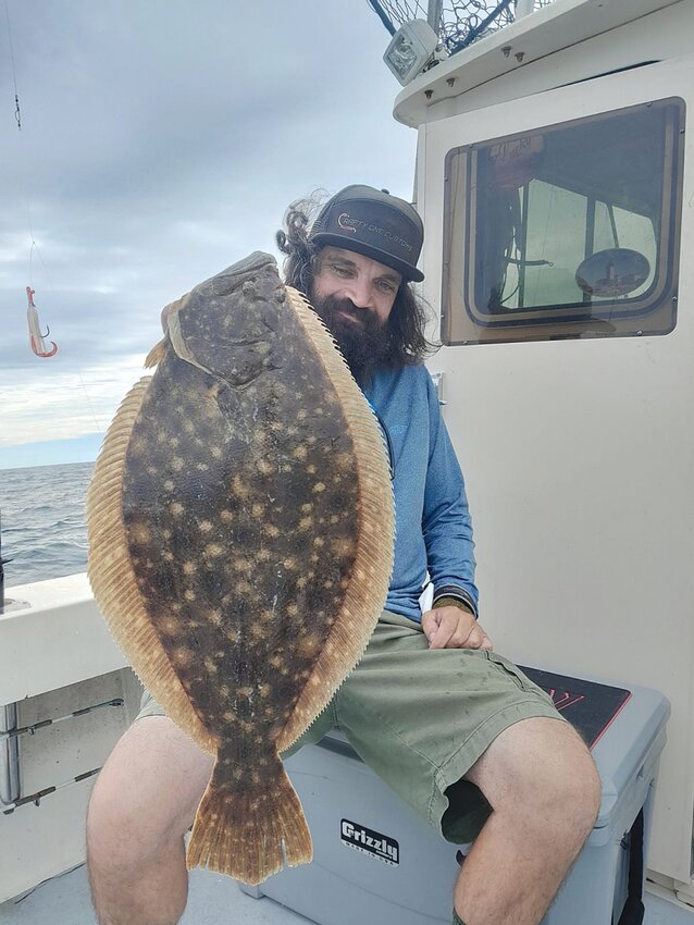 Jeff Sullivan with a monster fluke caught on light tackle with one of his squid rigs.