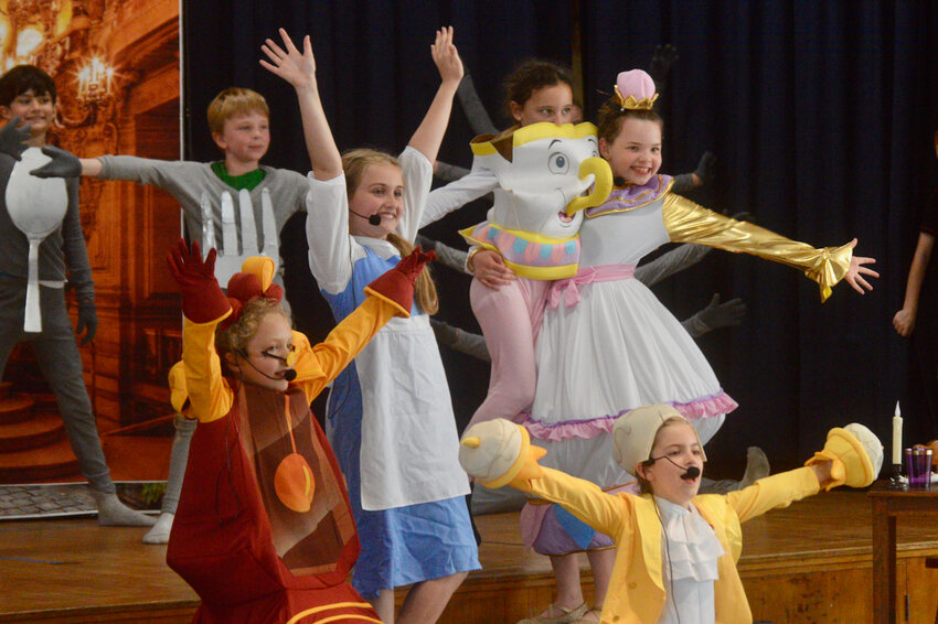 In Melville Elementary School&rsquo;s recent production of &ldquo;Beauty and the Beast,&rdquo; Natalie (center), as Belle, is feted by servants in The Beast&rsquo;s castle: Ari, Nate, Oonagh, Reese, Harper, and Mae.