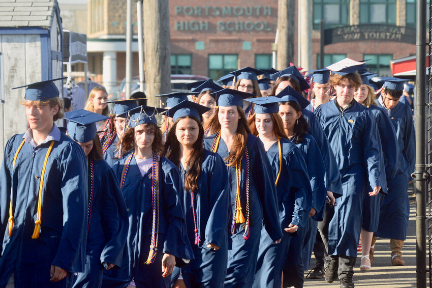 Members of the Class of 2024 walk away from Portsmouth High School one last time as they make their way to the athletic field to begin commencement exercises Friday night.