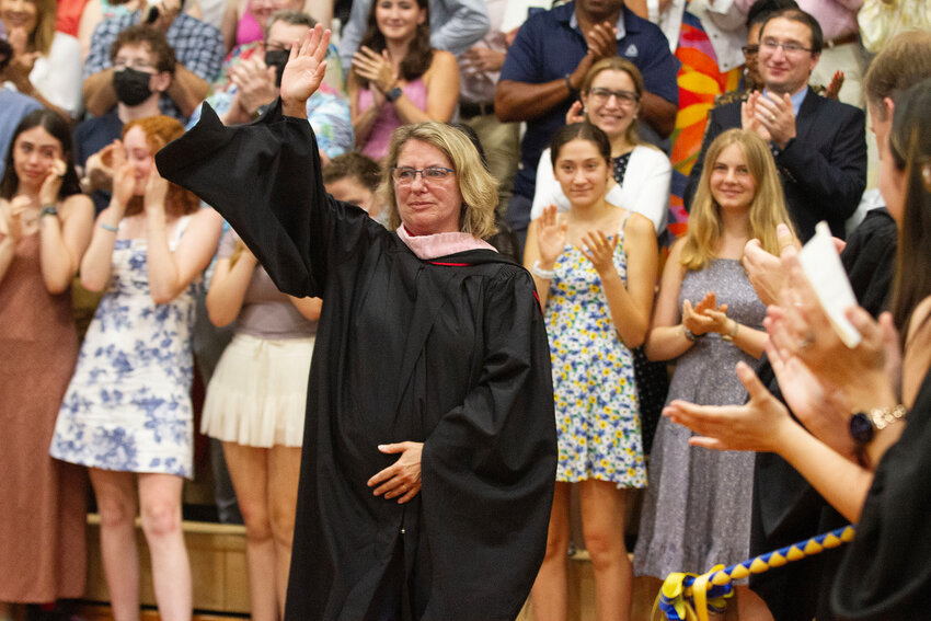 Retiring music and band teacher Barbara Hughes waves to the crowd during the Barrington High School graduation ceremony on Sunday, June 9.
