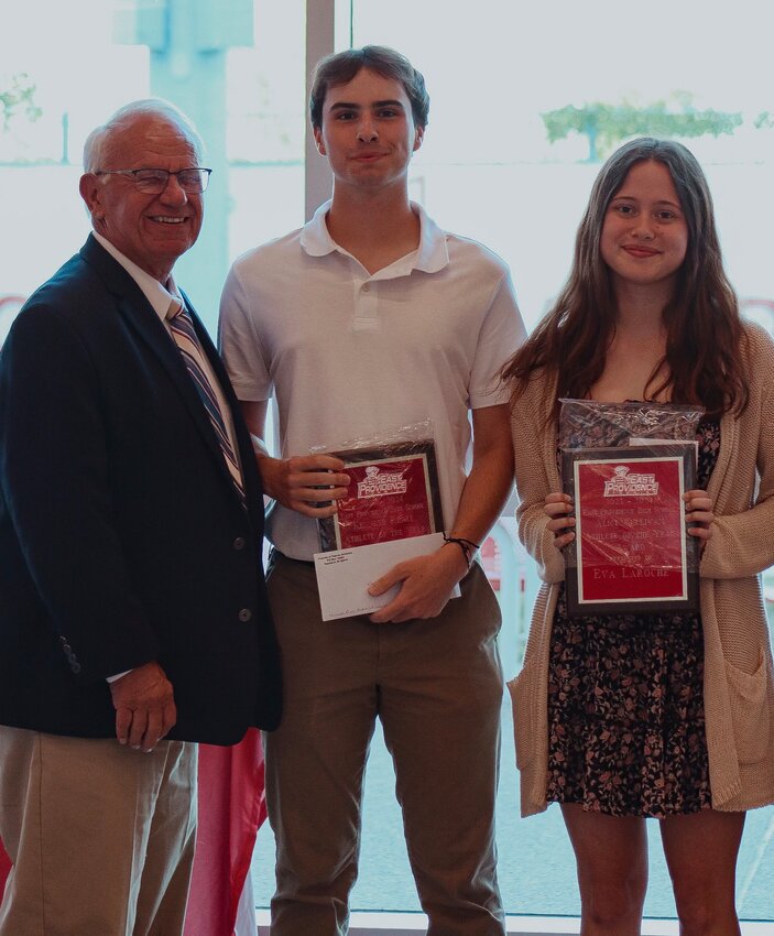 Former coach and administrator Ken Reall presents the 2023-24 EPHS Male and Female Athlete of the Year Awards, respectively, to Brayden Rouette and Eva Laroche.