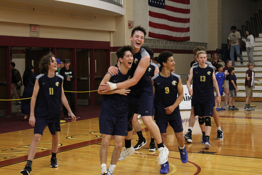 Members of the Barrington High School boys volleyball team celebrate after winning the Division II State Championship on Friday, June 7.