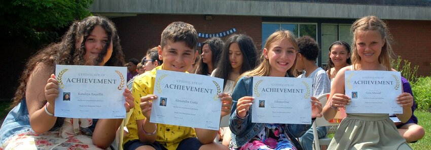 Kataleya Esquilin, Alexandre Costa, Liliana Cioe, and Cora Atwood hold up their certificates of achievement.