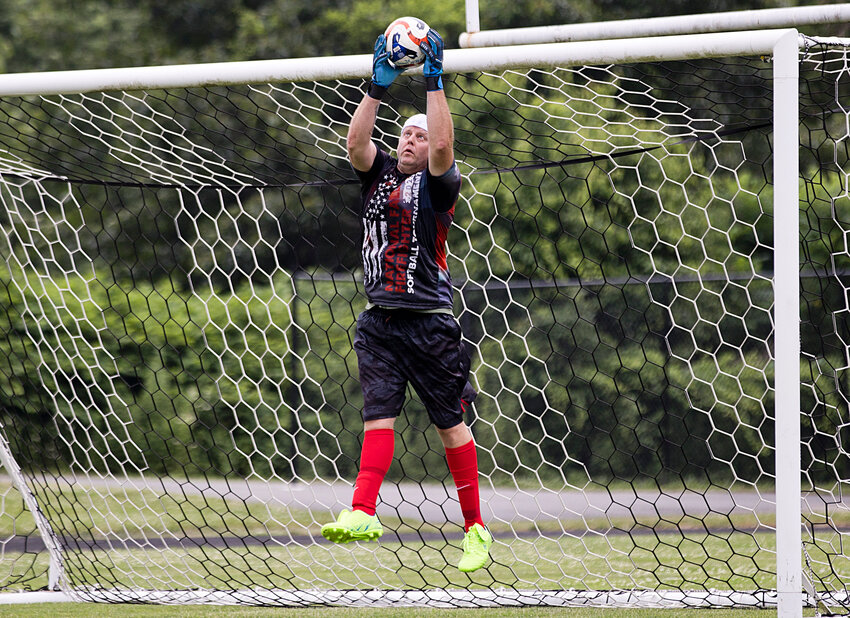 Eric Linacre, the goalkeeper for the combined East Providence Police and Fire Department and Emergency Management Agency soccer club, makes a save during his side's 3-1 victory over its opposition from the Warwick PD in a fundraiser played at Pierce Memorial Stadium Saturday, June 22.