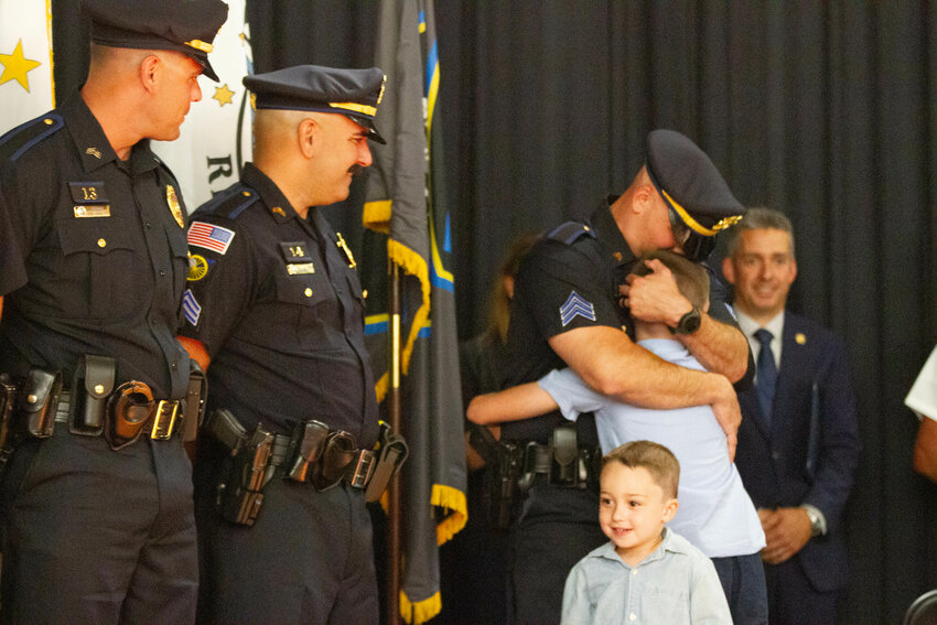 Officer Alexander Booth is pinned by sons, Nathan and Logan during his promotion to Sergeant.