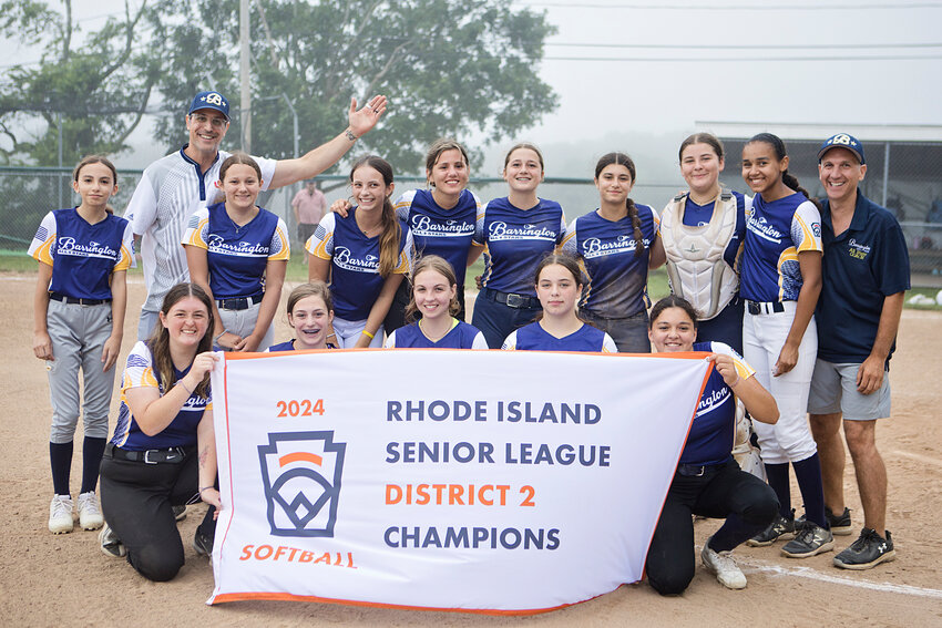 The Barrington Little League Seniors All Star softball team holds up the District 2 Championship banner after defeating Portsmouth on Wednesday night, June 26.