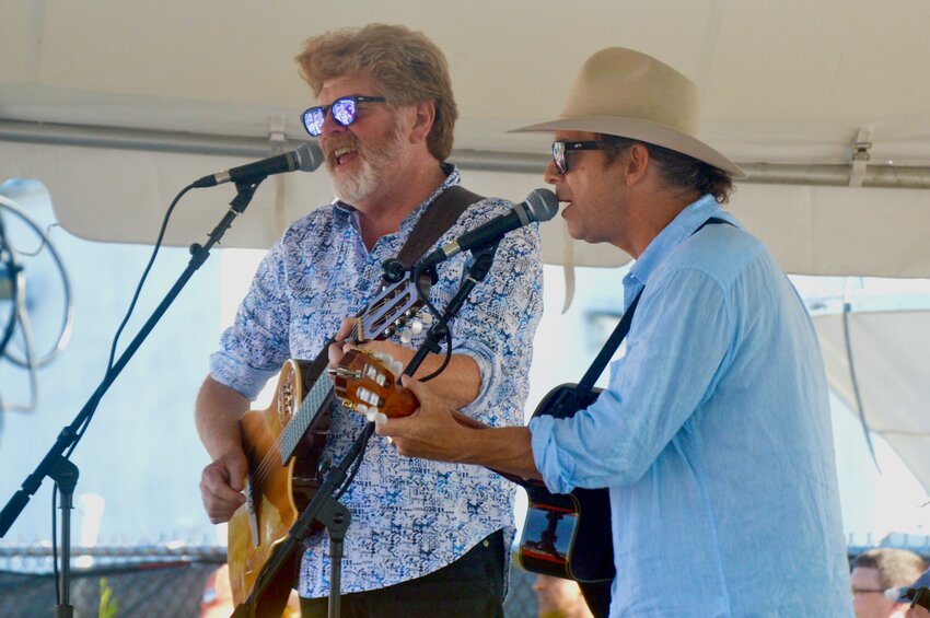 Mac McAnally (left) and Scotty Emerick of the Coral Reefer Band play a Jimmy Buffett song during a tribute concert to the late singer-songwriter on the back lawn at Sunset Cove in Island Park Tuesday, July 2. Buffett, who died of a rare skin cancer on Sept. 1, 2023, played his very last gig at the restaurant exactly one year before.