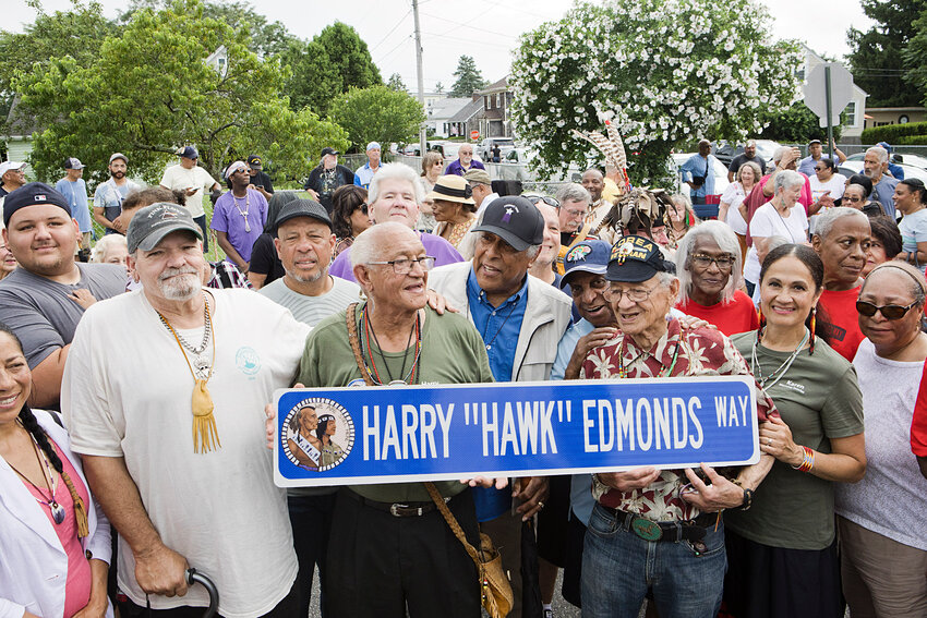 Harry &quot;Hawk&quot; Edmonds (center, green shirt) holds the street sign placed at the site honoring him and his family in the Hull Street Park neighborhood at the July 13 ceremony there.