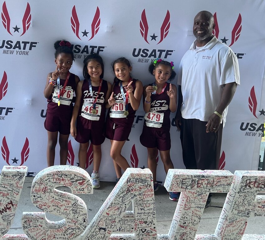 Members of the FAST TRACK youth track and field club's 7-8-year-old Region 1 and New England championship-winning 4x100 meter relay team included (from left to right) Saige James, Sarah Chin, Amalia Barroso Arias and Alaysiah Kane along with coach Ernest Fennell. The quartet are among several club athletes who have qualified for national meet next week at Texas A&amp;M University in College Station, Texas.