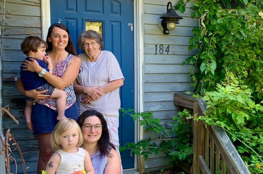 Little Compton Housing Trust board members (front) Isabel Mattia and (left, rear) Amanda Nickerson Toste and their children pose with board member Claudia McNeil in front of the trust's recently acquired house at 184 Colebrook Road in Little Compton.&nbsp;