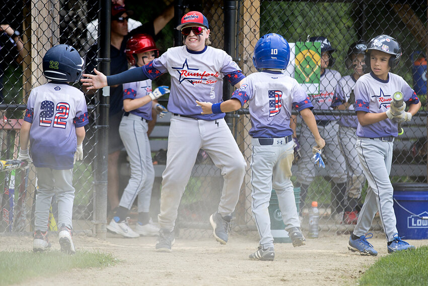 The Rumford All-Stars celebrate scoring a run in their Silva/District 2 Tourney game against Barrington on July 20.