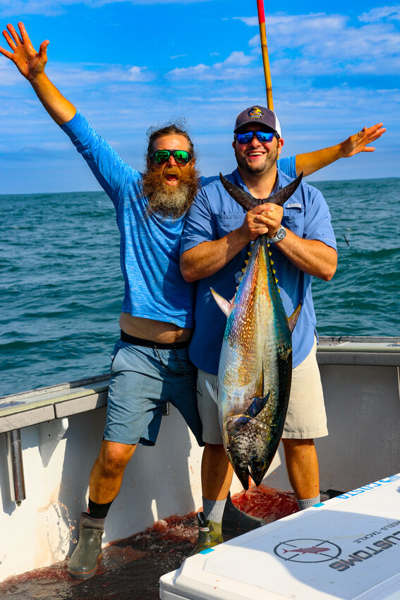 Capt. Rob Taylor of Newport Sport Fishing Charters celebrates the 60-pound bluefin tuna his client Mark Battista caught last week.