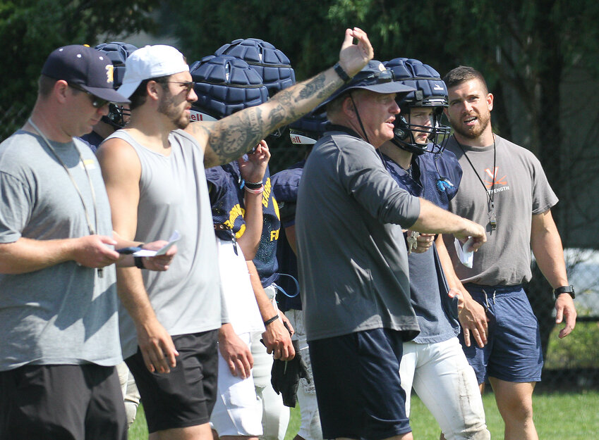 Barrington High School coaches offer instruction to players during preseason practice last week.