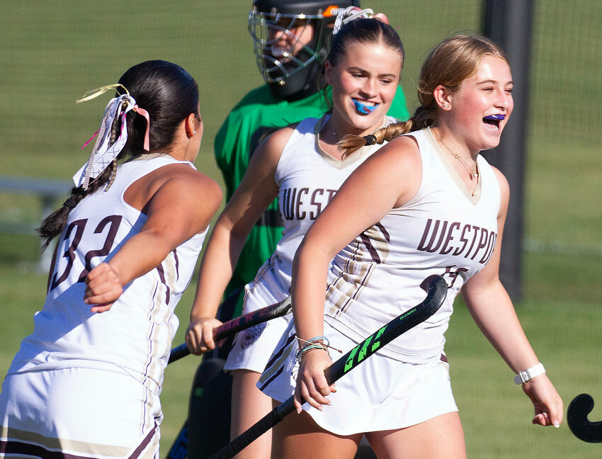 Forwards Kaylin Pacheco (left) and Makayla Grace celebrate with Maddie Melnyk (right) after Melnyk scored her first goal of the game in the Wildcats' 6-1 win over Carver on Tuesday. Melynk, a freshman, tallied all six goals for Westport.