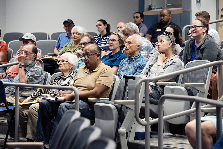 Hans Scholl (second row, second from right) listens to the candidates speak during a forum last week at the Barrington Public Library.