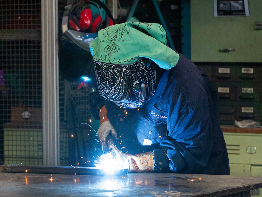 Afi Goncalves welds a piece of metal at the Steel Yard.