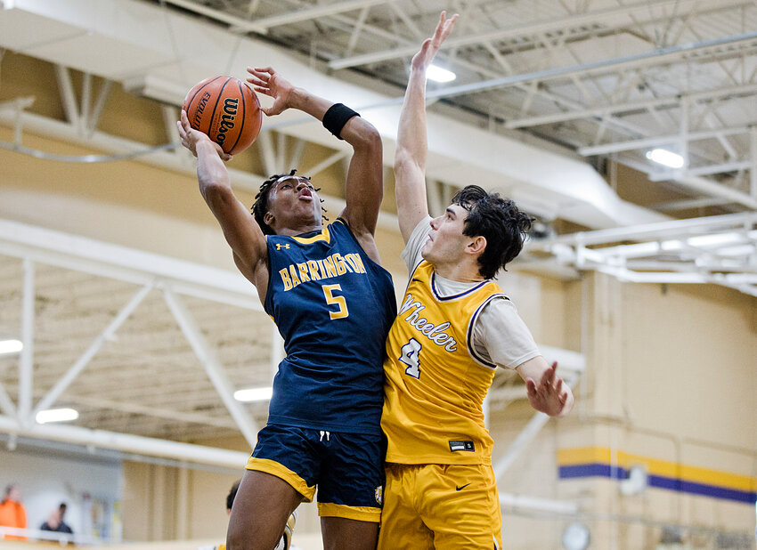 Caleb Satisfield (left), shown elevating for a basket against Wheeler, led all Barrington scorers with 25 points in the Eagles' victory over Smithfield.
