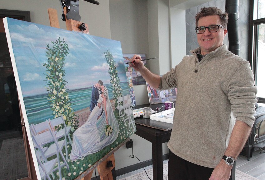 Mark DeSilva puts some finishing touches on his latest oil painting.