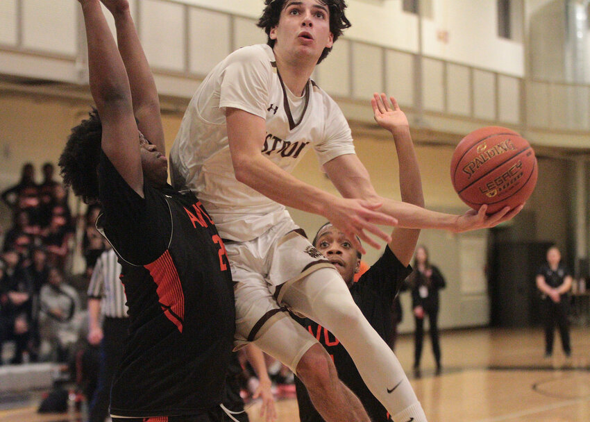 Owen Boudria drives in between defenders for a layup in the fourth quarter.