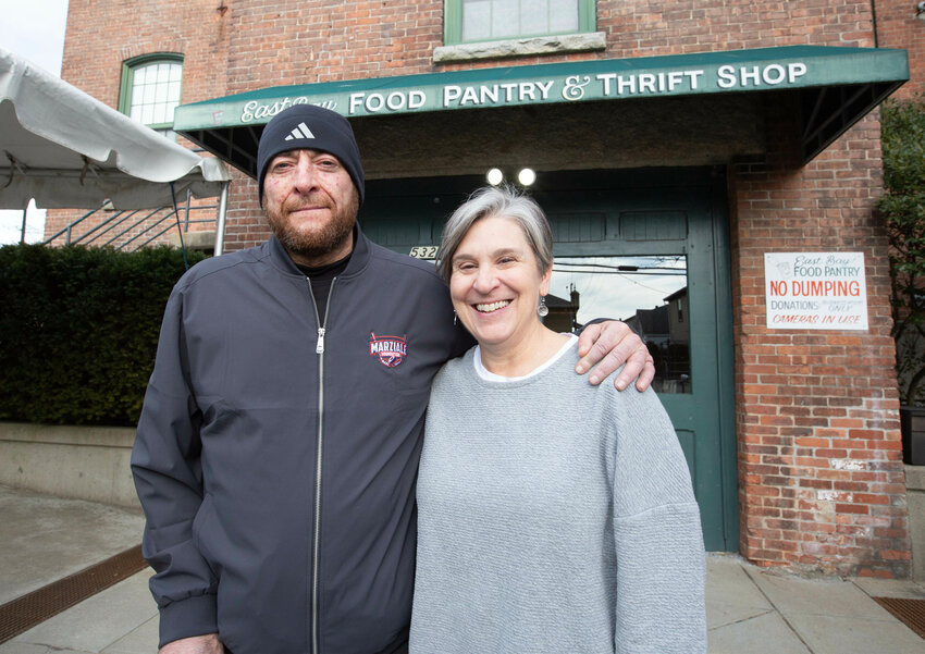 Ralph Marziale (left) and Jocelyn King (right), who have partnered to collect food donations for those in need, stand outside the East Bay Food Pantry and Thrift Shop.