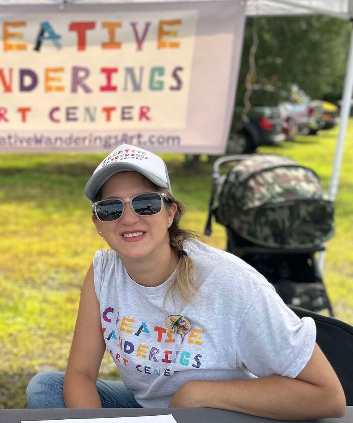 Ashley Ernest sits outside her camper van turned mobile art studio on a beautiful day.&nbsp;&nbsp;  &nbsp;