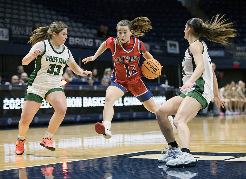 Portsmouth High&rsquo;s Violet Silvia leaps through a pair of Ponaganset defenders to advance the ball during the Final Four matchup won by the Chieftains Saturday at the University of Rhode Island.