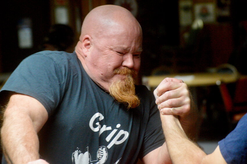 Rick North grimaces during arm wrestling practice at the VFW Post 5390 in Common Fence Point last Thursday night. North is organizing a tournament there on April 12 to raise money toward a needed sprinkler system at the hall.