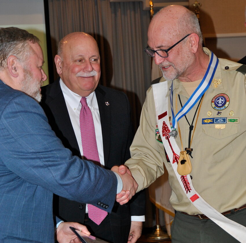Barrington resident Marc Millspaugh (right) receives an award from the Narragansett Council Scouting America, recognizing his 24 years of service.
