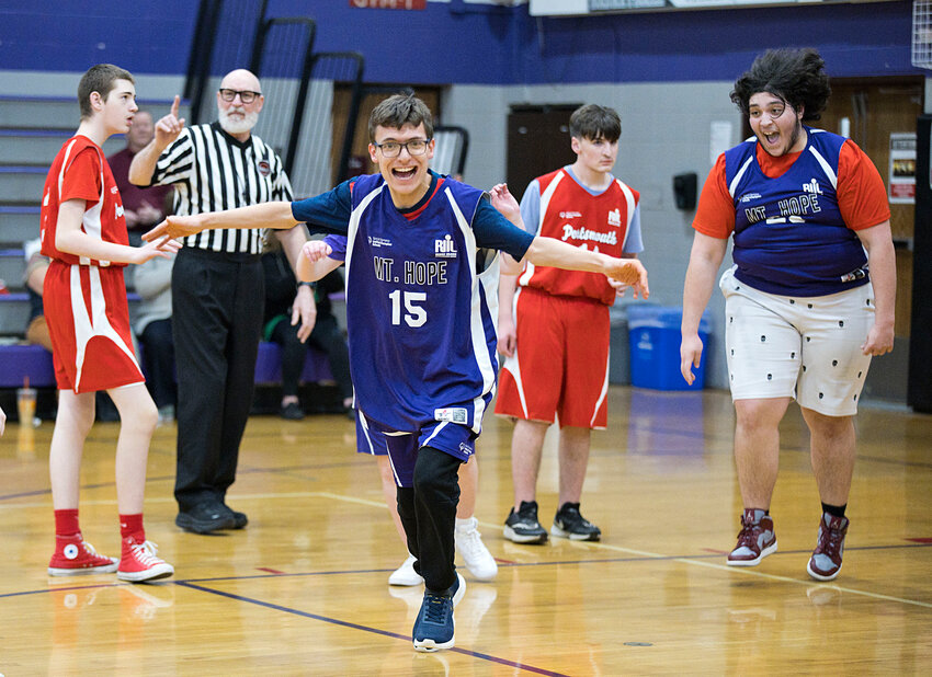 Joe Pedulla celebrates hitting a late-game shot for the Mt. Hope High School Unified Basketball League squad against Portsmouth March 18 with teammate Mike Scaloro (far right)