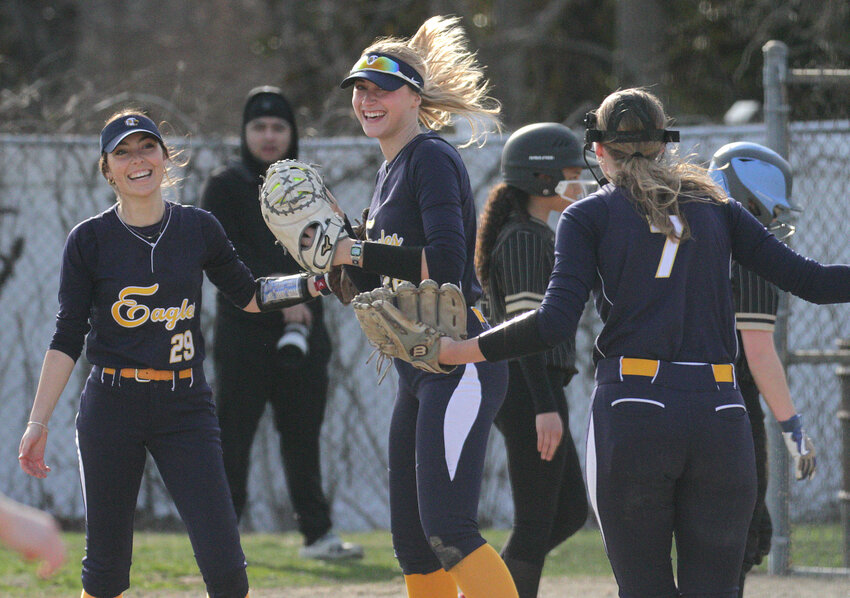 Second baseman Alyssa Conaty (left) and first baseman Ruby Ciummo (center) celebrate an out with pitcher Kendall Fisher during a recent game against Davies.
