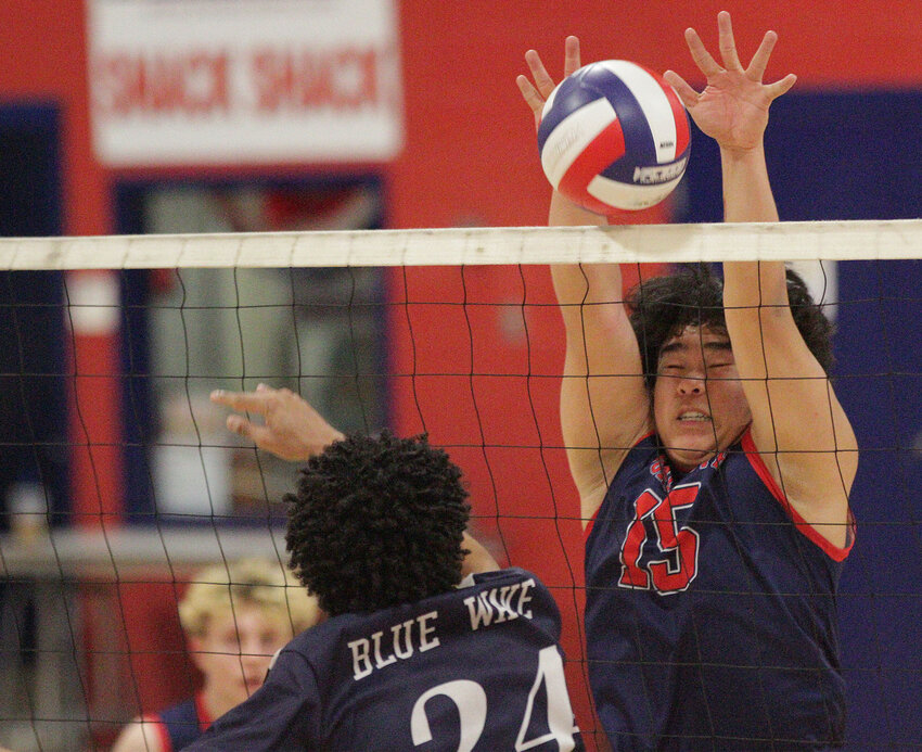 Portsmouth&rsquo;s Alexander Goss blocks a slam from a Hope High School opponent Monday night in the PHS field house.