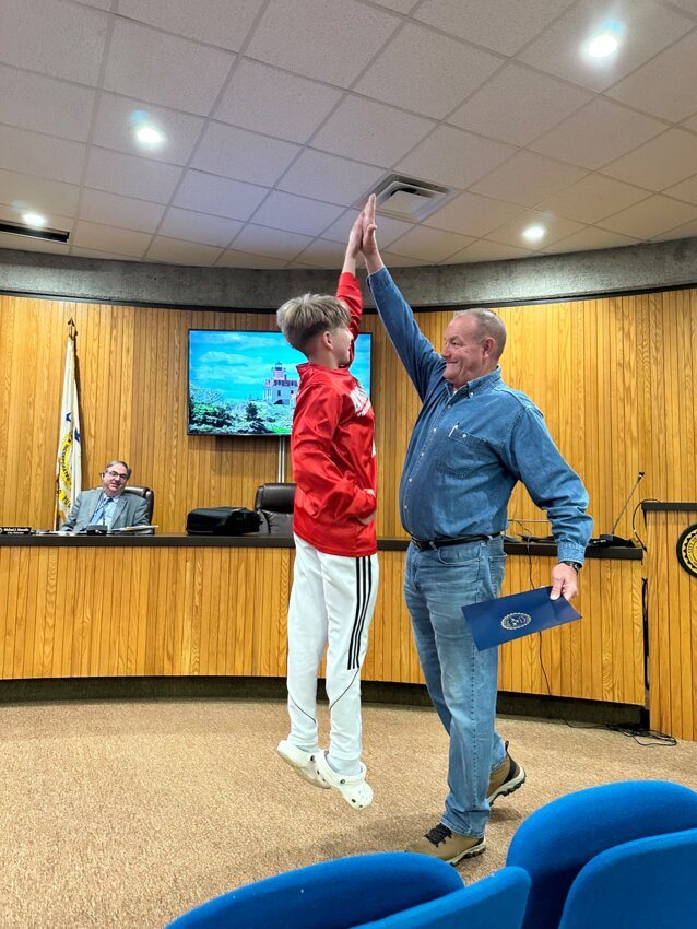 Ward 3 Councilman and long-time youth league referee Frank Fogarty delivered certificates of recognition to each playet from the 5th grade boys travel team with a customary jump high five.